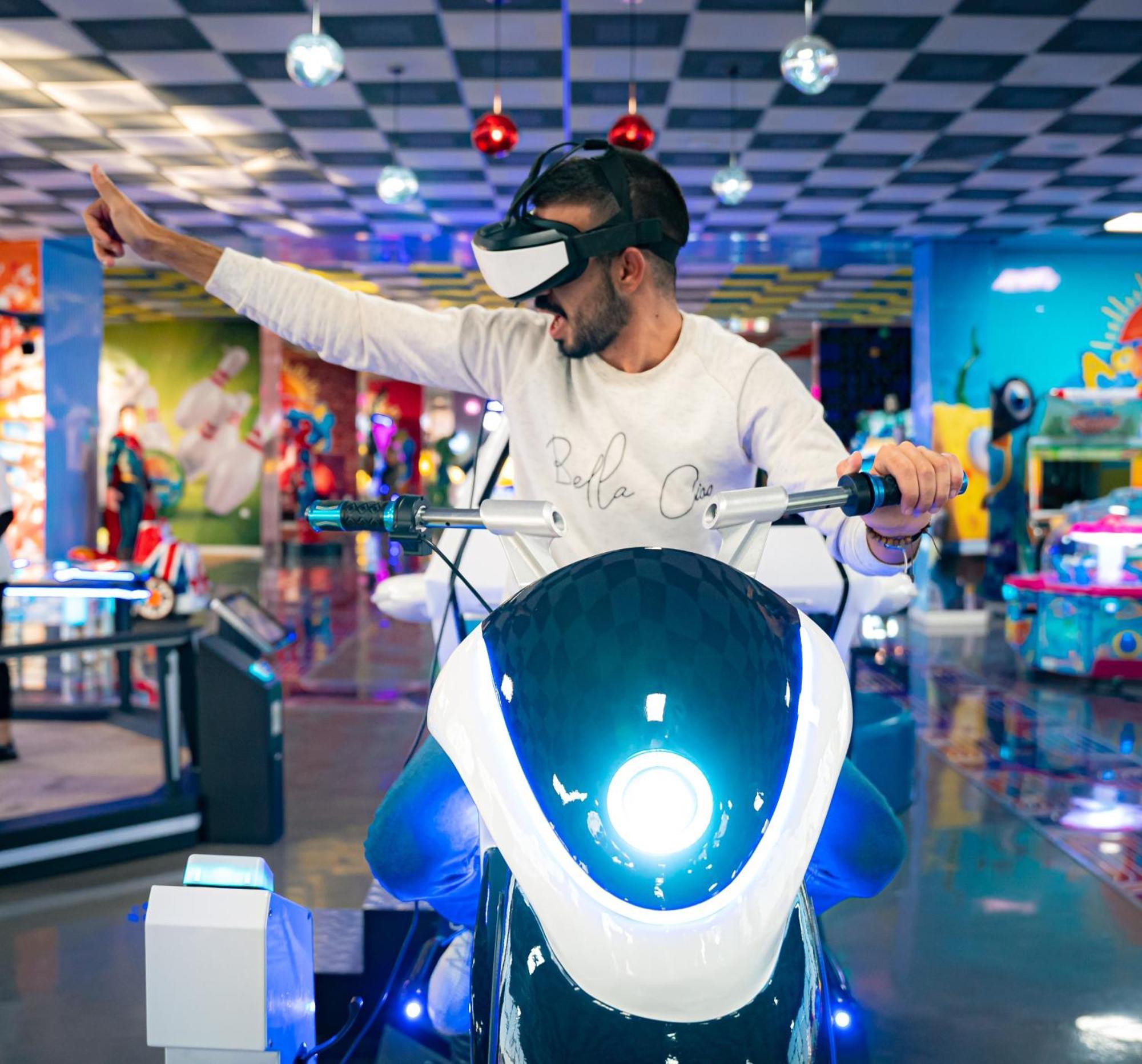 Waves Aqua Resort Kenitra Exterior photo A man playing a motorcycle racing game with a virtual reality headset